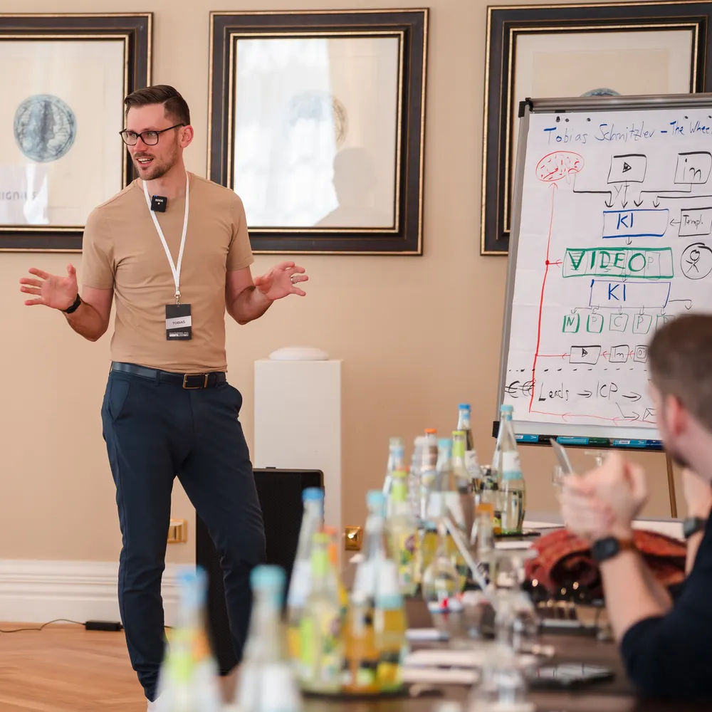 Tobias Schnitzler im Workshop vor einem Flipchart, an dem er einen KI-gestützten Ablauf aufgezeichnet hat